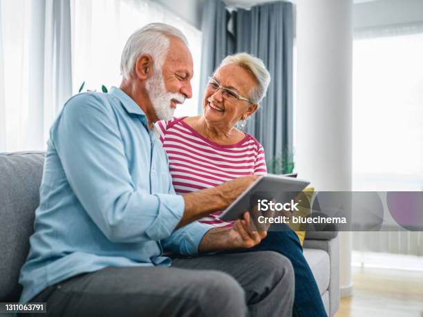 Senior Couple Buying Some Goods Online Stock Photo - Download Image Now - Digital Tablet, Mature Couple, Indoors