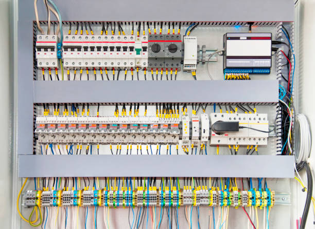 istock Electrical switchboard with different colored wires, switches and sensors 1311063902