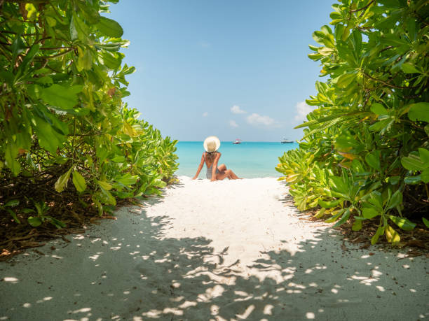 istock Young woman sunbathing on tropical beach 1311063933