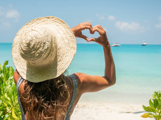 istock Young woman sunbathing on tropical beach loving vacations 1311064145