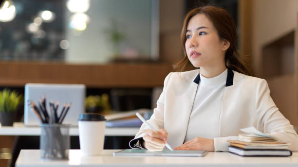 istock Half-length portrait of entrepreneur looking forward while working with digital tablet 1311065640