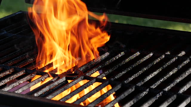 Slow motion close-up of burning fire flame on grill