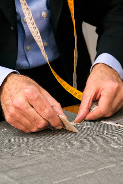 istock hands of an Italian tailor measuring a tailored suit 1311068182