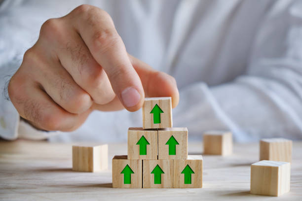 istock Building wooden blocks with green arrows, growth concept 1311068589