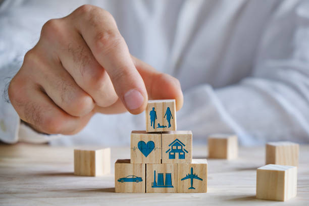 istock Wooden blocks with icons of various types of insurance 1311068607