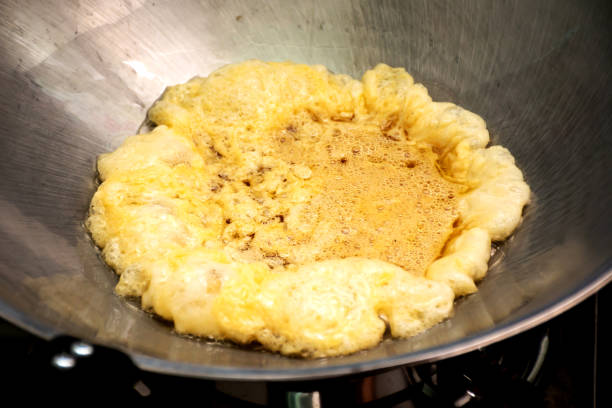 istock Omelet cooking in the frying pan. 1311069268
