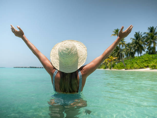 istock Young woman wants inside tropical lagoon arms outstretched 1311070027