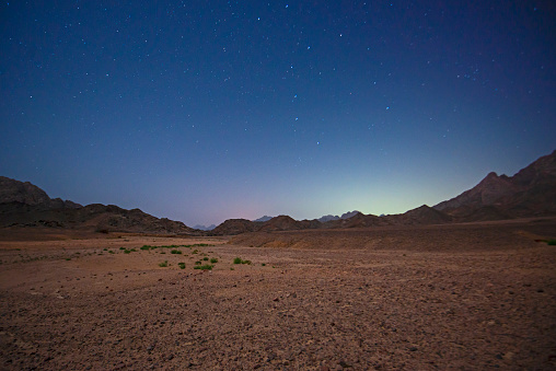 Landscape scenic view of desolate barren eastern desert mountain range in Egypt at night with stars