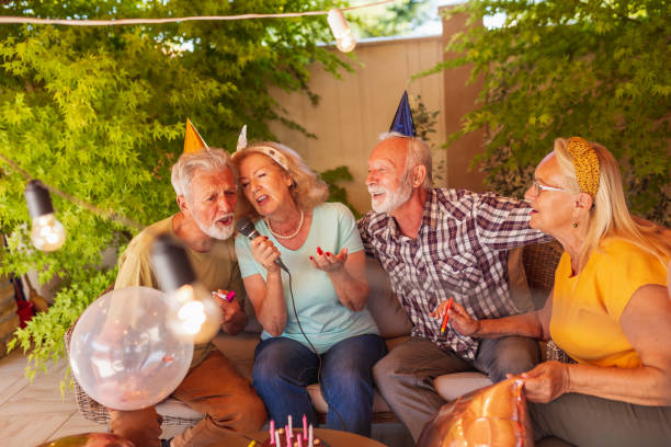 istock Senior friends singing karaoke while celebrating birthday 1311070935
