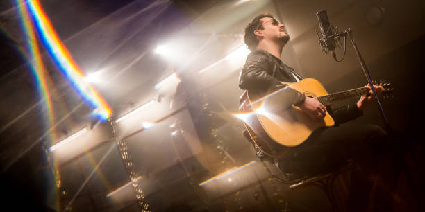 istock Male singer singing song in studio 1311071368