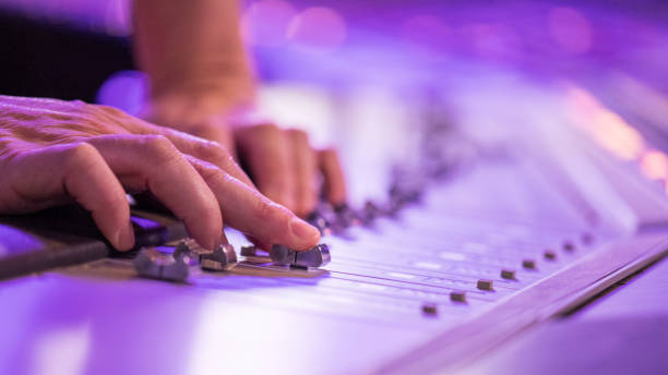 istock Human hand adjusting buttons on audio mixer 1311071419
