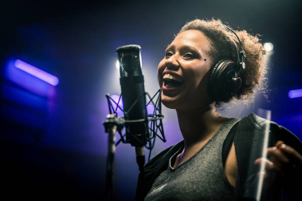 istock Female singer singing song in studio 1311071442