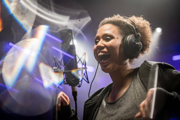 istock Female singer singing song in studio 1311071498