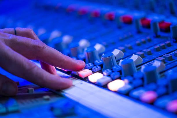 istock Human hand adjusting buttons on audio mixer 1311071500