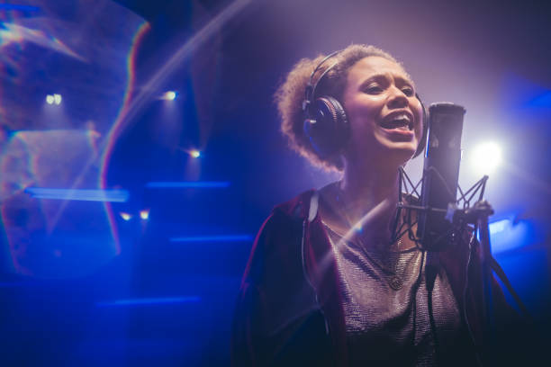 istock Female singer singing song in studio 1311071573