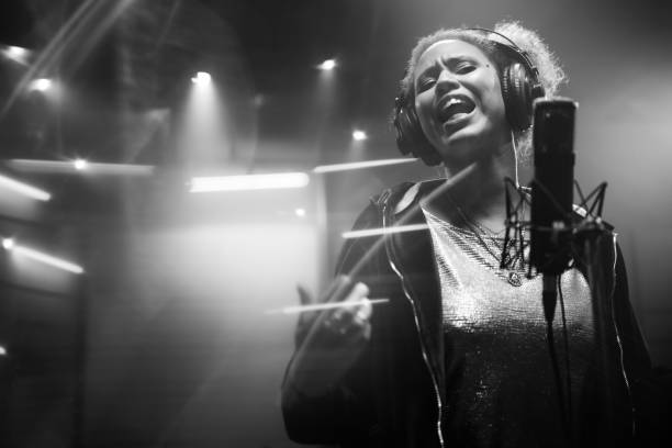 istock Female singer singing song in studio 1311071883