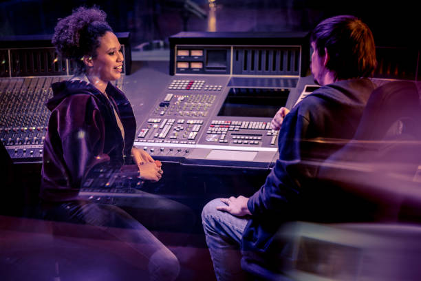 istock Woman talking with composer in recording studio 1311071885