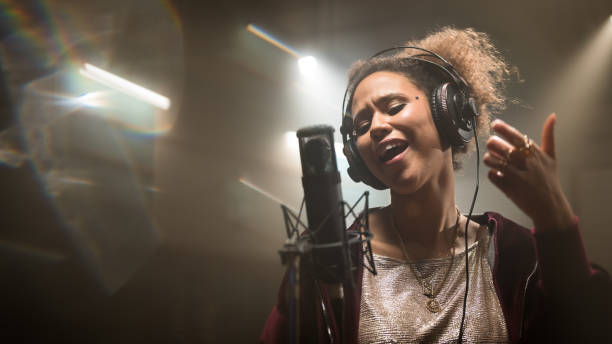 istock Female singer singing song in studio 1311071918