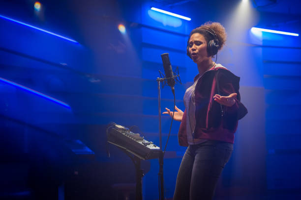 istock Female singer singing song in studio 1311071985