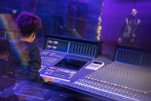 istock Female composer operating sound mixer 1311072004