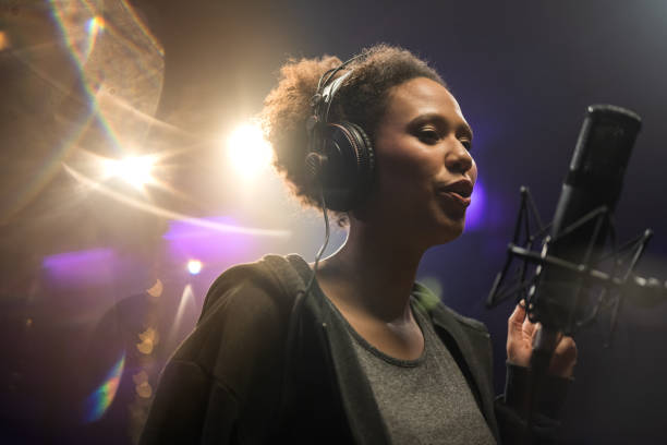 istock Female singer singing song in studio 1311072550