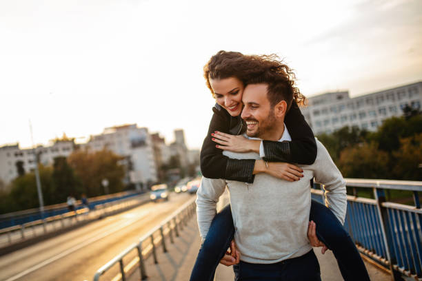istock Happy young couple embracing laughing on date 1311073649