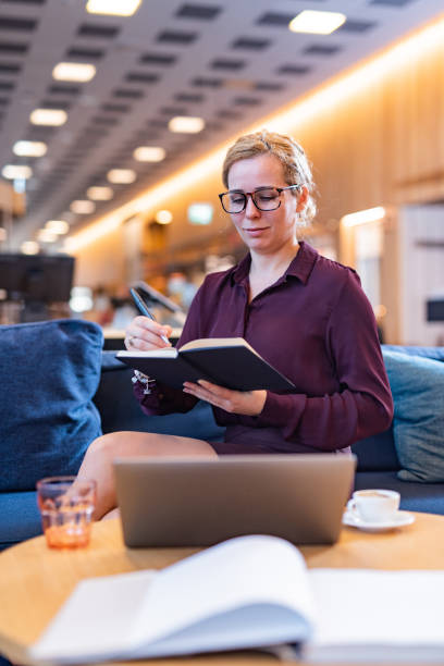 istock Happy business woman writing something in office 1311073666
