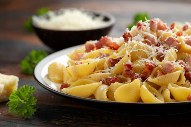 istock Classic Pasta carbonara with bacon, egg, cream, black pepper and Parmesan Cheese on plate. Italian food 1311073763