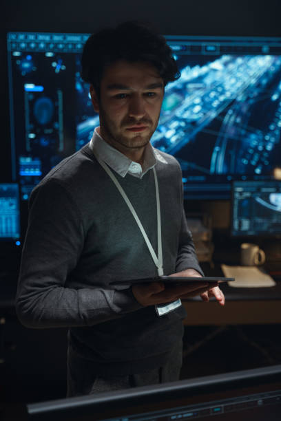 istock A scowling man holds a tablet in his hands and looks away 1311074861