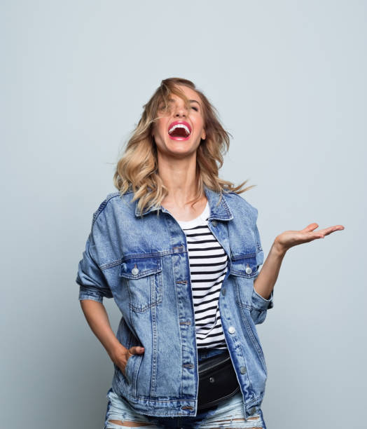 istock Happy young woman in oversized jeans jacket 1311075001
