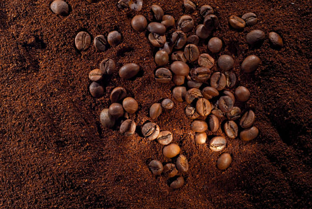 istock Coffee beans close up. Texture of ground and grain coffee. Contrasting dramatic light as an artistic effect. 1311076334