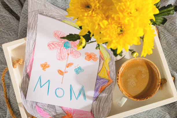 un regalo de un niño para el día de las madres - una tarjeta de una foto y café en la cama en la mañana - pencil colors heart shape paper fotografías e imágenes de stock