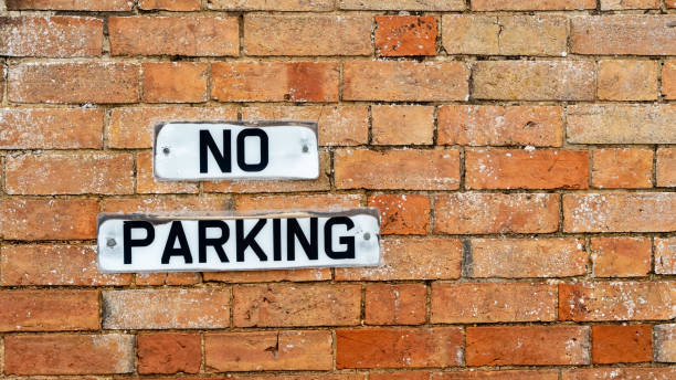 No Parking sign made from UK number plates on an old brick wall No Parking sign made from UK number plates on an old brick wall no parking sign photos stock pictures, royalty-free photos & images