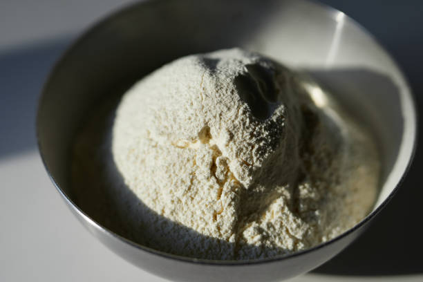 istock Sifted flour in a metal bowl on white board with hard light 1311079224