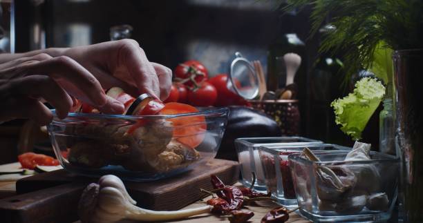 istock Preparing chicken fillet with tomatoes and eggplants 1311080856