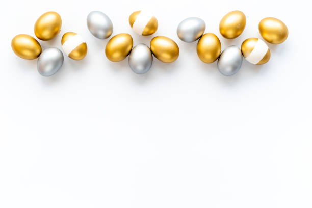 istock Silver and golden eggs isolated on white background. Easter decoration background. Top view 1311081770