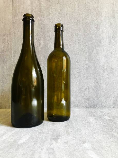 istock two dark wine bottles stand on the table. 1311082822