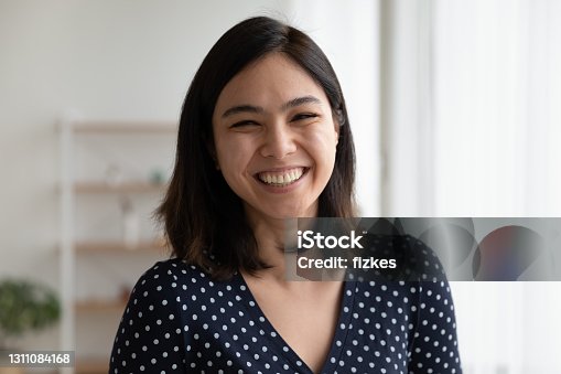 istock Overjoyed pretty asian woman look at camera with sincere laughter 1311084168