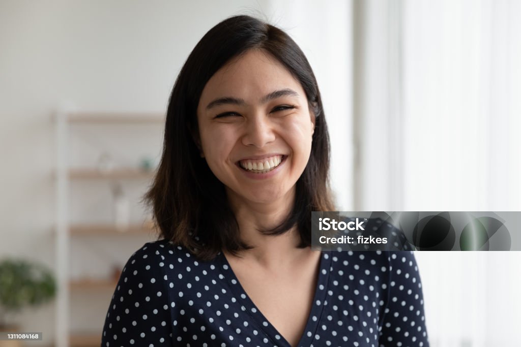 Overjoyed pretty asian woman look at camera with sincere laughter Portrait of happy overjoyed pretty asian woman look at camera with sincere laughter. Laughing excited female customer leave positive video feedback to ordered goods received service on company website Women Stock Photo