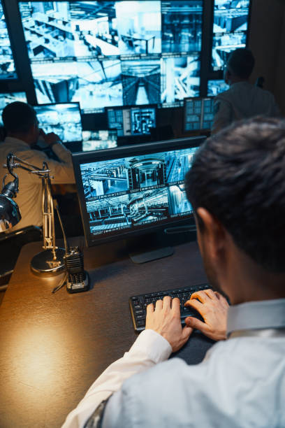 istock Three security personnel are at their work stations. The security room has large monitors and a modern security system. In case of illegal entry into the security facility, the alarm will be triggered. 1311084195
