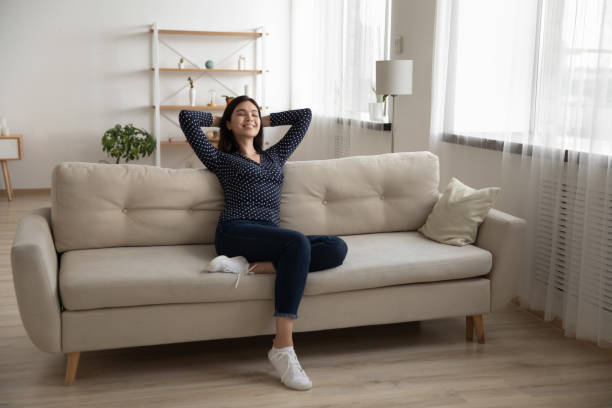 istock Peaceful vietnamese lady chill nap on couch at modern apartment 1311084393