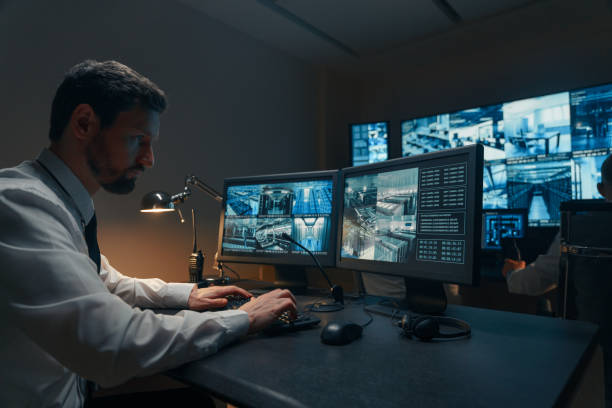 Security guards monitoring modern CCTV cameras indoors Security guards monitoring modern CCTV cameras indoors control room stock pictures, royalty-free photos & images
