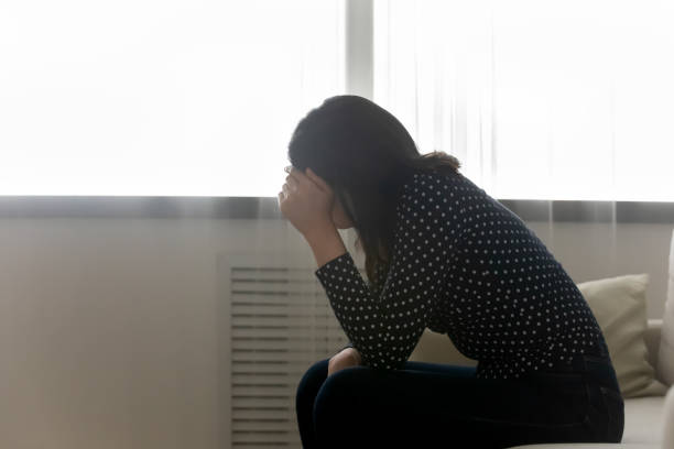 istock Desperate young woman sit on bed suffering having psychological problem 1311084718