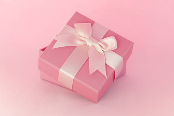 istock Beautiful gift with bow standing on blue background 1311084889