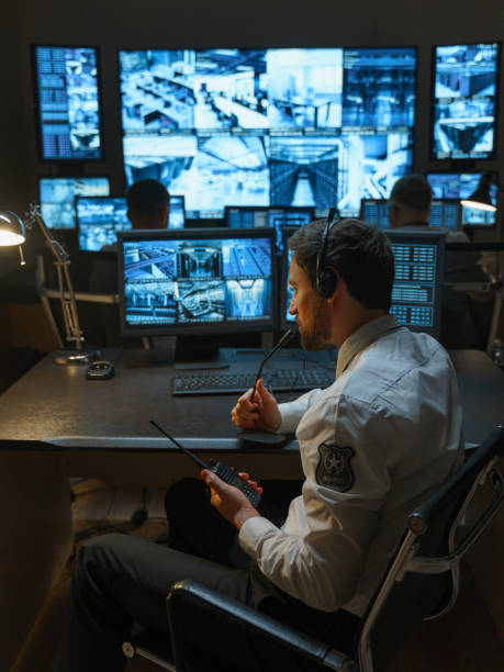 istock In the office of the security service equipped with high-tech tracking systems, employees work at their workplaces. 1311085358