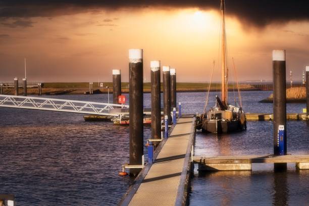 istock Old sailing boat in harbor with beautiful colored sunset 1311085449