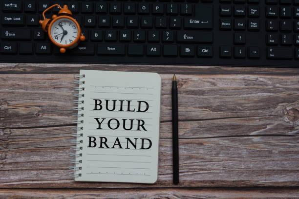 istock Build your brand text a notepad with alarm clock on a keyboard 1311085712
