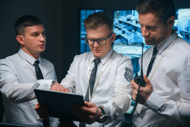 istock Security officers discuss their actions and tasks that they will have to perform in this night shift. 1311086249