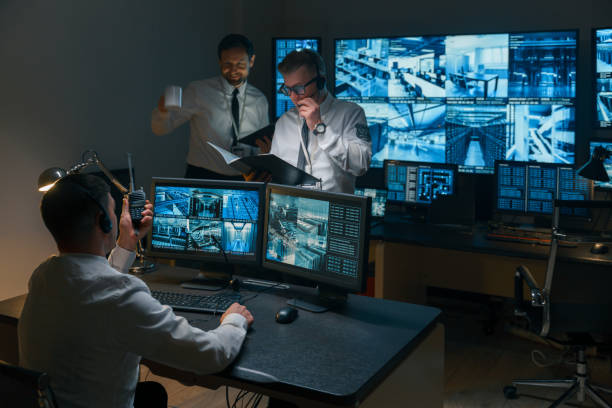 istock Photo of the process of working in the central security office. Three security guards work the night shift, they do the daily work. 1311087086