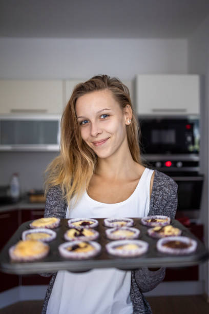istock Pretty, young woman baking gluten free cupkes 1311087283